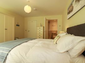 A bedroom with a bed and wardrobe at Pen-Y-Les Wadebridge