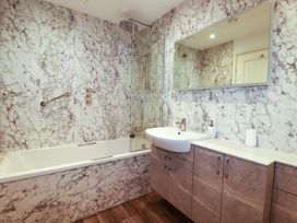 A bathroom with a bathtub and sink at Pen-Y-Les in Wadebridge