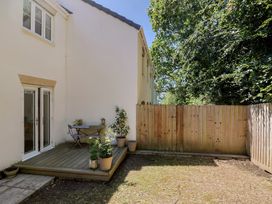 A garden with decking, table, and chairs at 22 Applebee Way Lyme Regis