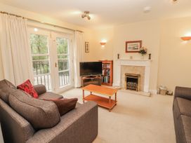 A living room with a television and fireplace at Flat 17 in Keswick