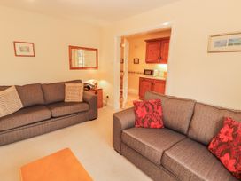 A living room with two sofas and a view to the kitchen at Flat 17 in Keswick