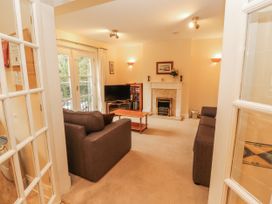 A living room with a television and sofas at Flat 17 in Keswick