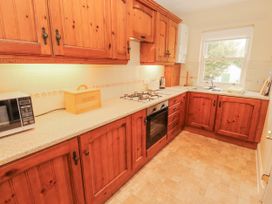 A kitchen with cabinets and appliances at Flat 17 in Keswick
