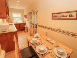 A dining room with a table set for meals at Flat 17 in Keswick