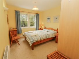 A bedroom with a bed and a chair at Flat 17 in Keswick