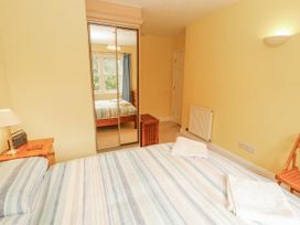 A bedroom with a bed and a mirror at Flat 17 in Keswick