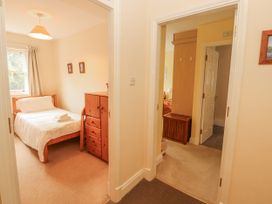A bedroom with a bed and storage furniture at Flat 17 in Keswick