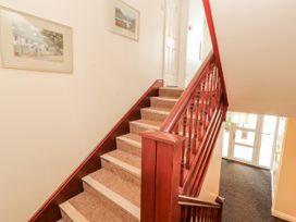 A staircase with framed pictures on the wall at Flat 17 in Keswick