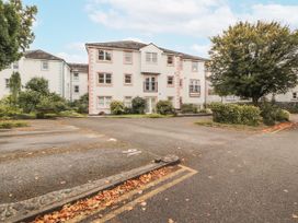 A building with parking lot and trees at Flat 17 in Keswick