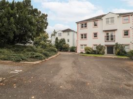 A parking lot with buildings and greenery at Flat 17 in Keswick