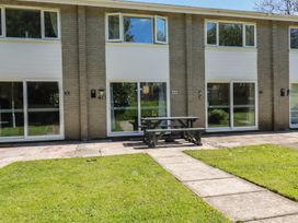 An outdoor area with buildings and a picnic table at 64 St Columb Nr Newquay
