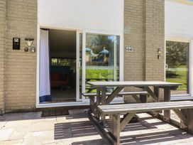 An outdoor area with a table and bench at 64 St Columb Nr Newquay