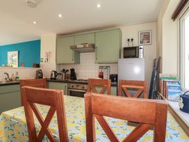 A kitchen with a table and chairs at 64 St Columb Nr Newquay