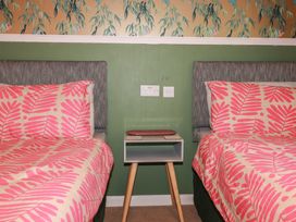 A bedroom with two beds and a nightstand at 64 St Columb Nr Newquay