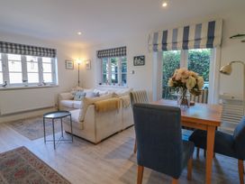 A living room with a sofa and dining area at November Cottage in Dittisham