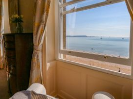 A view of the beach and sea from a window at 123 On The Sea – Victoria’s Place in Weymouth