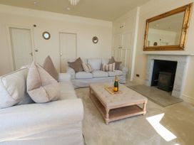 A living room with a sofa and coffee table at 123 On The Sea – Victoria’s Place in Weymouth