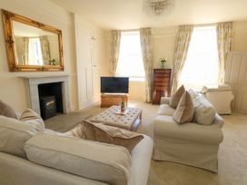 A living room with a sofa and television at 123 On The Sea – Victoria’s Place, Weymouth