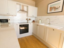 A kitchen with cabinets, sink, oven and microwave at 123 On The Sea – Victoria’s Place, Weymouth