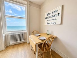 A dining room with a table and chairs at 123 On The Sea – Victoria’s Place, Weymouth