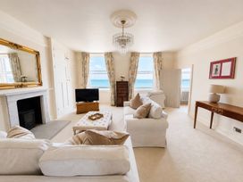 A living room with a television and a coffee table at 123 On The Sea – Victoria’s Place, Weymouth