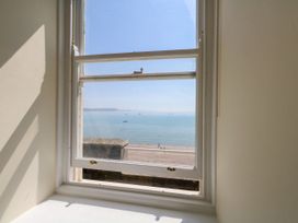 A view of the sea and beach from a window at 123 On The Sea – The Eaves Weymouth