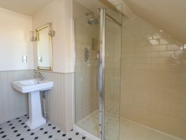 A bathroom with a shower and wash basin at 123 On The Sea – The Eaves, Weymouth
