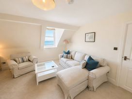 A living room with a sofa and coffee table at 123 On The Sea – The Eaves, Weymouth