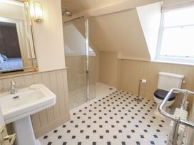 A bathroom with a sink, shower, and toilet at 123 On The Sea – The Eaves Weymouth