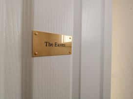 A door with a nameplate reading The Eaves at The Eaves in Weymouth