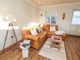 A living room with a sofa and a side table at Nene's Nest in Alnwick