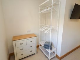 A bedroom with a clothes rack and drawers at Nene's Nest in Alnwick