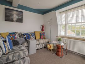 A living room with a sofa and coffee table at Jasper in Lyme Regis