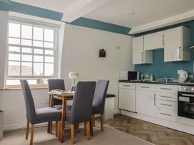 A kitchen with table and chairs at Jasper in Lyme Regis