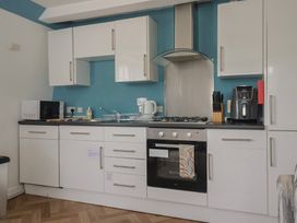 A kitchen with appliances and cabinets at Jasper in Lyme Regis