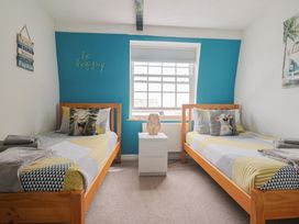 A bedroom with two beds and a window at Jasper in Lyme Regis