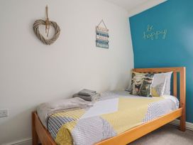 A bedroom with a bed and wall decorations at Jasper in Lyme Regis