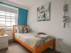A bedroom with a bed and nightstand at Jasper in Lyme Regis