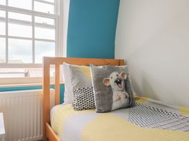 A bedroom with a bed and a pillow at Jasper in Lyme Regis