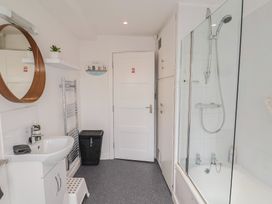 A bathroom with sink, shower, and bathtub at Jasper in Lyme Regis