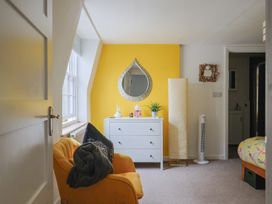 A bedroom with a mirror and dresser at Jasper in Lyme Regis