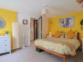 A bedroom with a bed and dresser at Jasper in Lyme Regis
