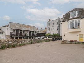 A parking lot with buildings and cars at Jasper in Lyme Regis