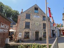 An outdoor area with a building and seating at the Town Mill in Lyme Regis