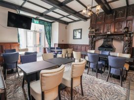 A dining room with tables and chairs at Woodlands Retreat Llanfwrog near Ruthin