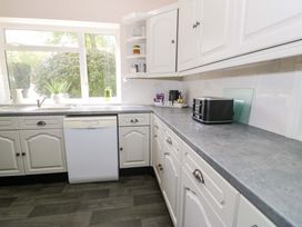 A kitchen with a dishwasher and toaster at Woodlands Retreat Llanfwrog near Ruthin