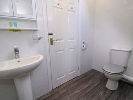 A bathroom with a sink and toilet at Woodlands Retreat in Llanfwrog near Ruthin
