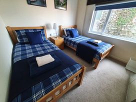 A bedroom with two single beds and a nightstand at Lynmouth View in Lynmouth