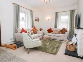 A living room with sofas and an armchair at 3 Nixon Terrace Broughton Moor near Maryport
