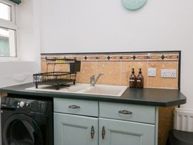 A kitchen with a sink and cabinets at 3 Nixon Terrace in Broughton Moor near Maryport